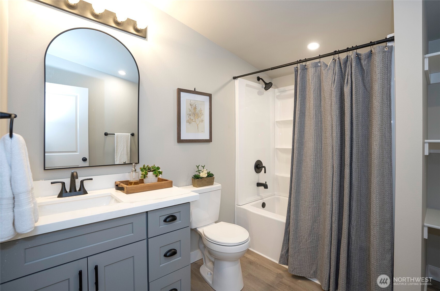 22902 Keating Road Orting, WA 98360 - Photo 25 of 40 a bathroom with a toilet a sink a mirror a vanity and shower