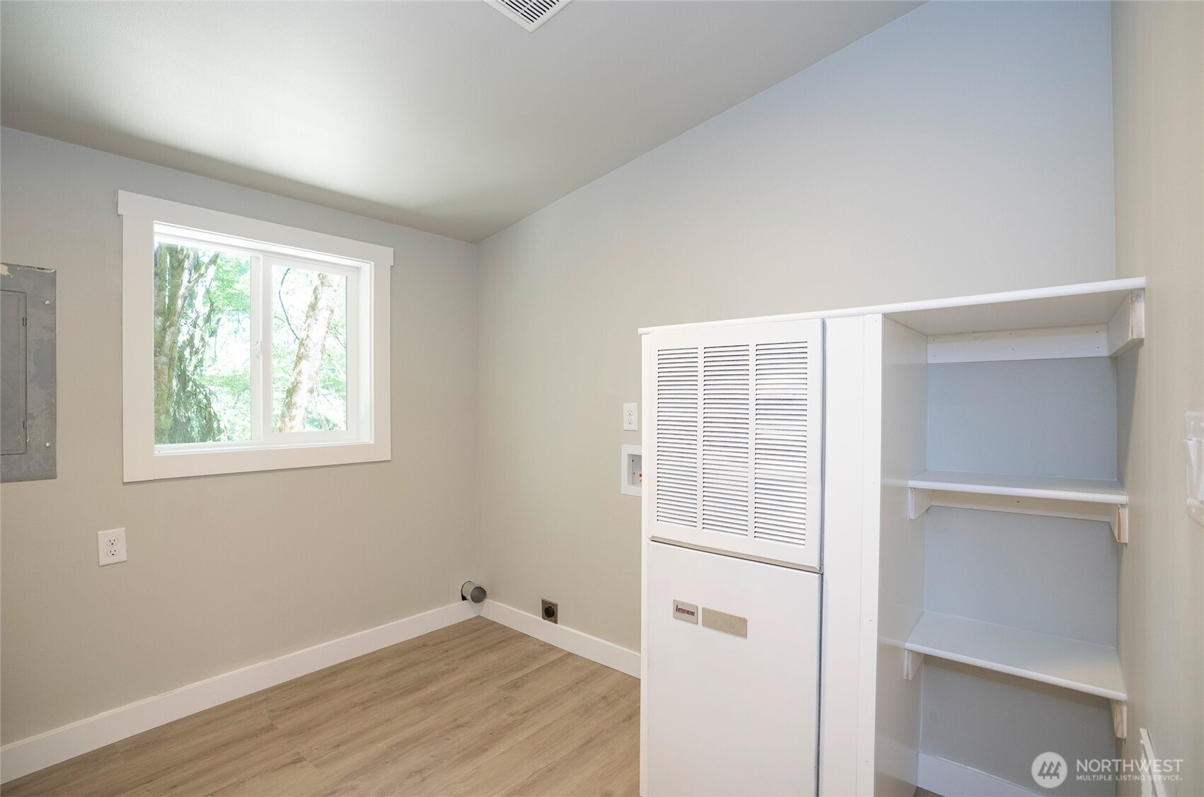 22902 Keating Road Orting, WA 98360 - Photo 35 of 40 a view of an empty room with wooden floor and a window