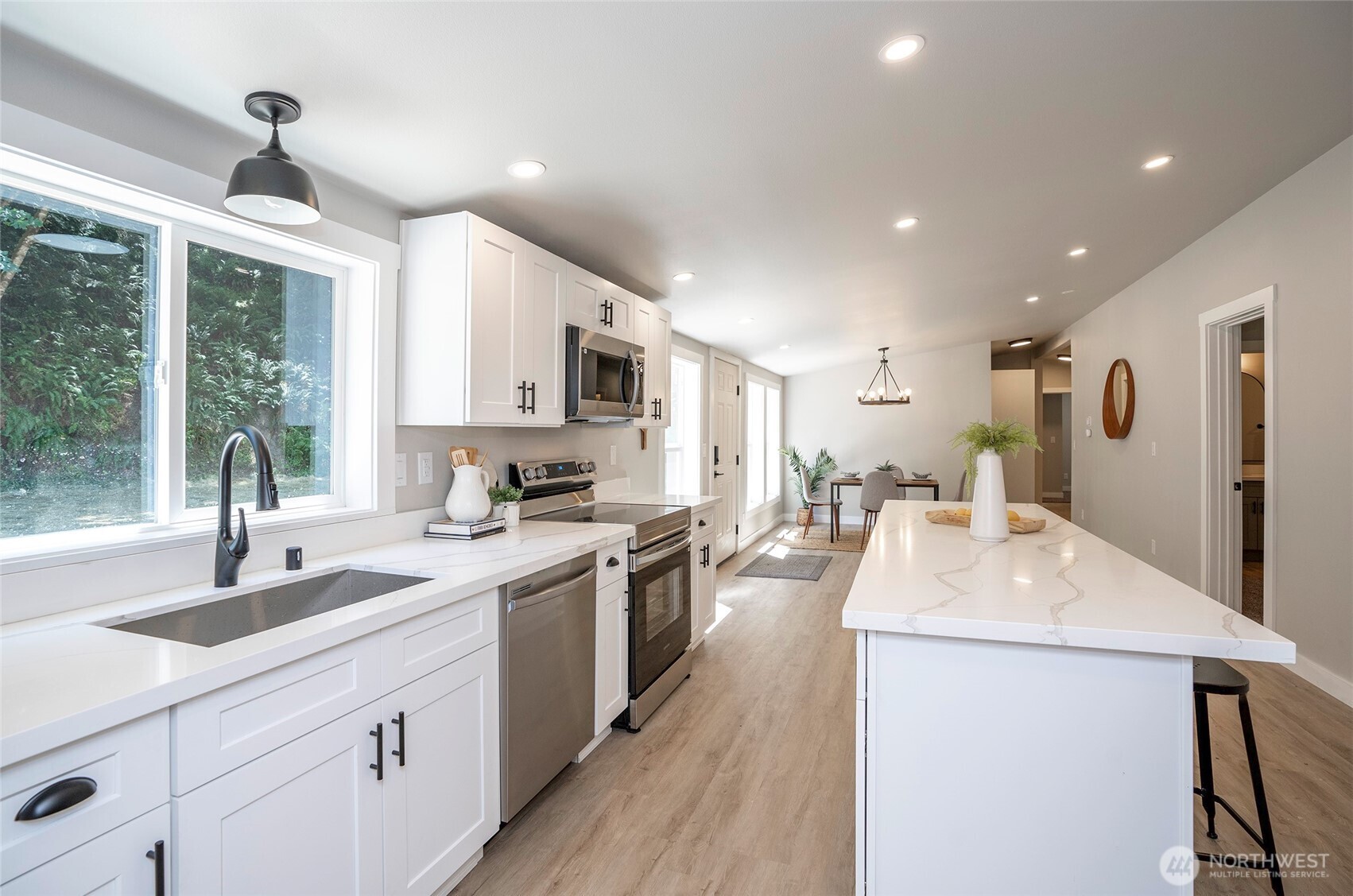 22902 Keating Road Orting, WA 98360 - Photo 9 of 40 a large kitchen with kitchen island a sink stainless steel appliances and cabinets