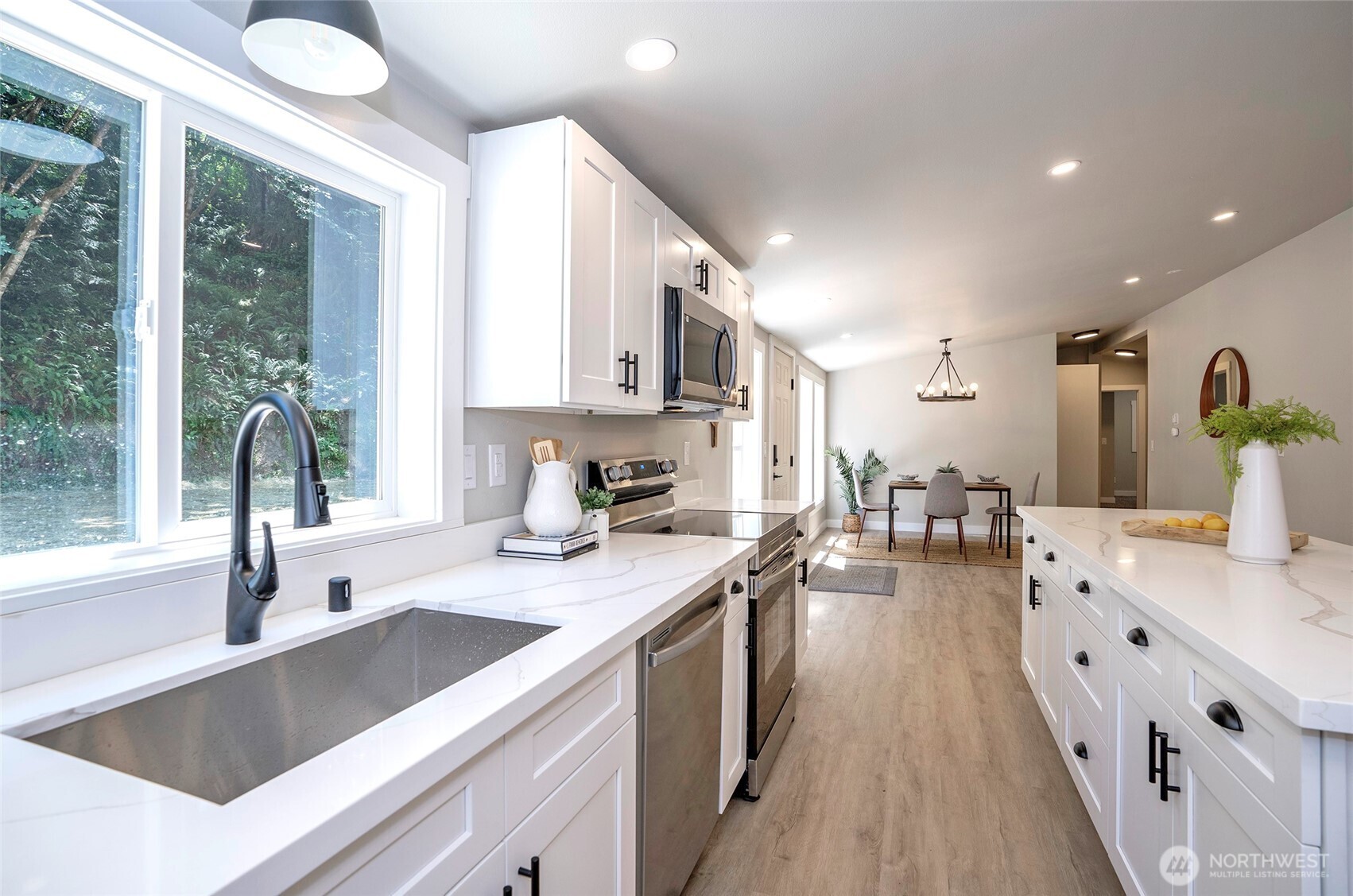 22902 Keating Road Orting, WA 98360 - Photo 10 of 40 a kitchen with counter top space a sink cabinets and appliances