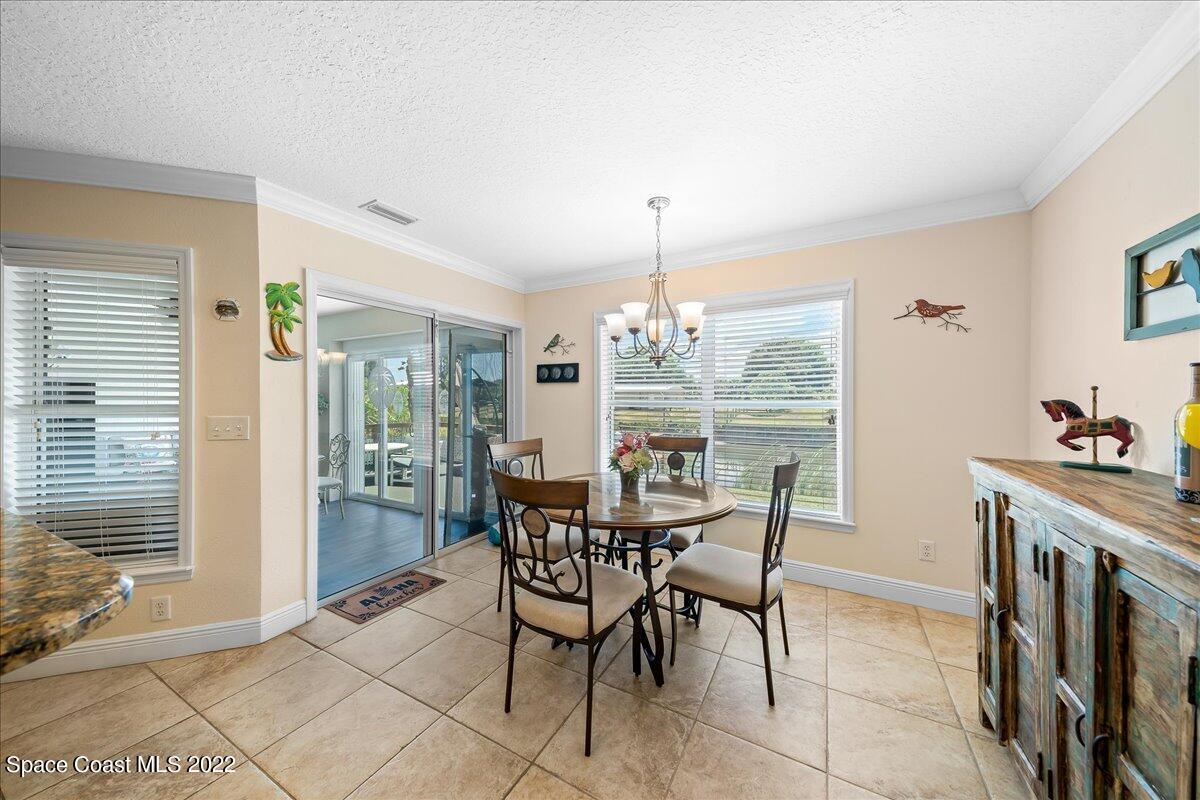 5265 Evinrude Road Melbourne, FL 32934 - Photo 15 of 42 a view of a dining room with furniture window and outside view