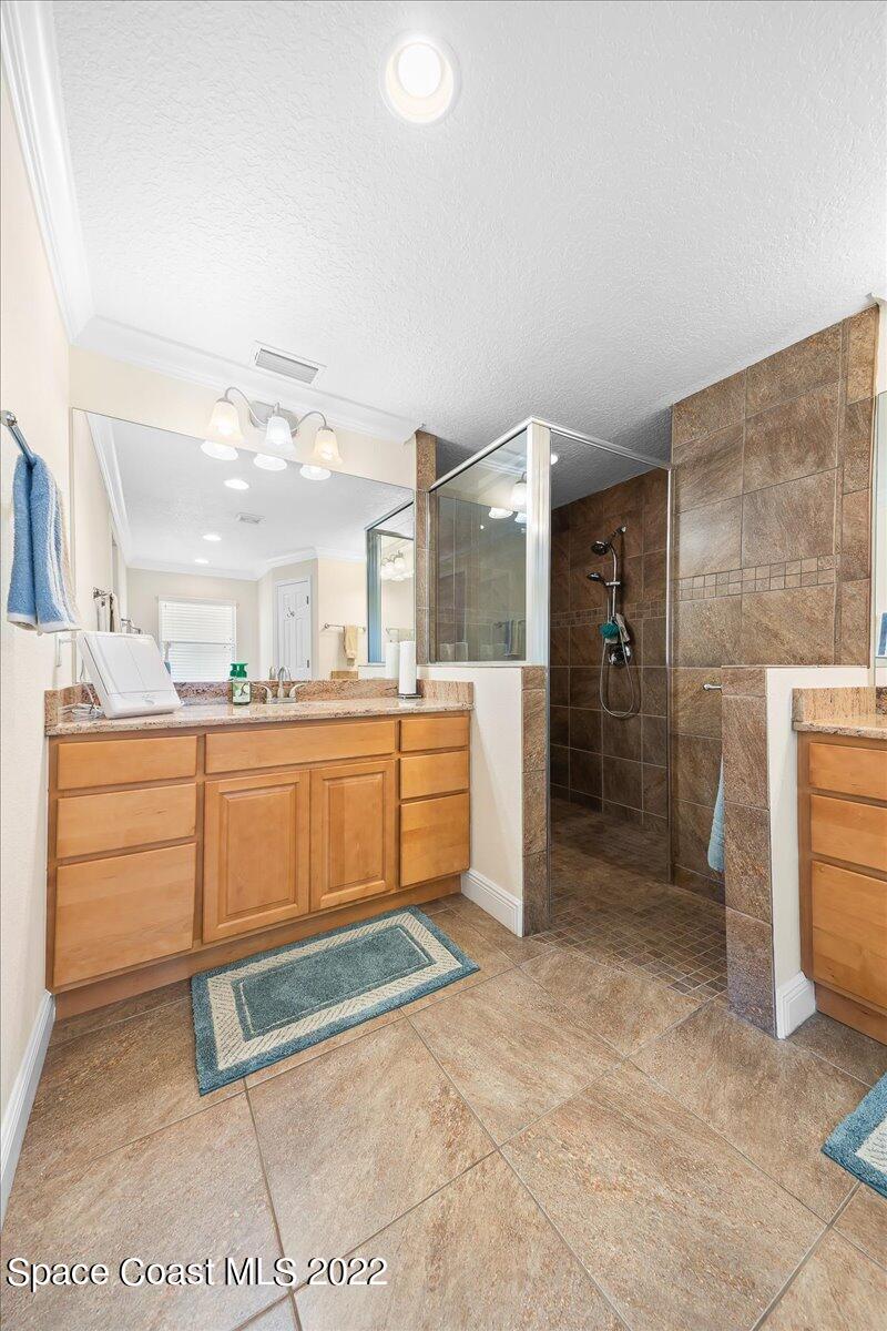 5265 Evinrude Road Melbourne, FL 32934 - Photo 20 of 42 a room with kitchen island a sink and a refrigerator