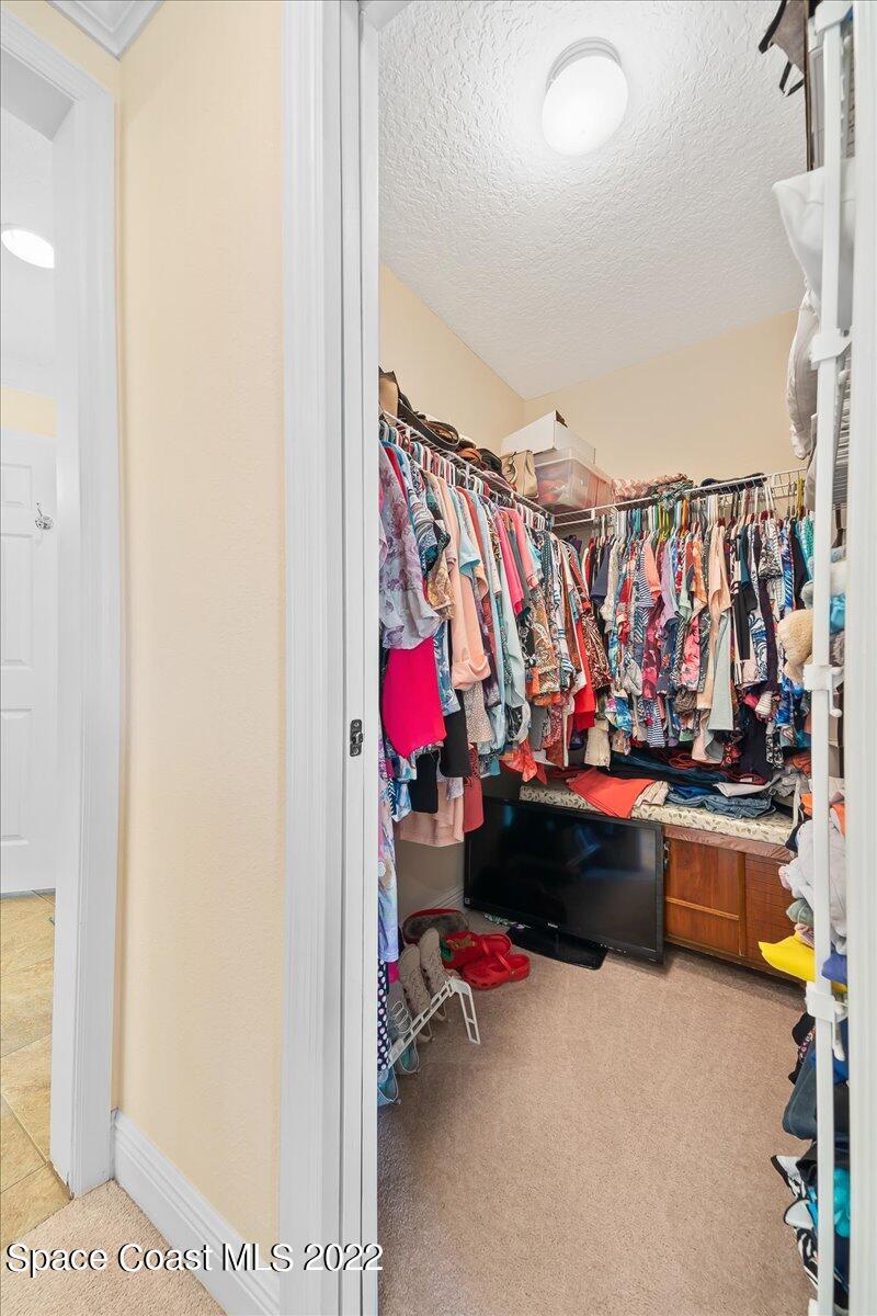 5265 Evinrude Road Melbourne, FL 32934 - Photo 21 of 42 a bed room with furniture and a couch