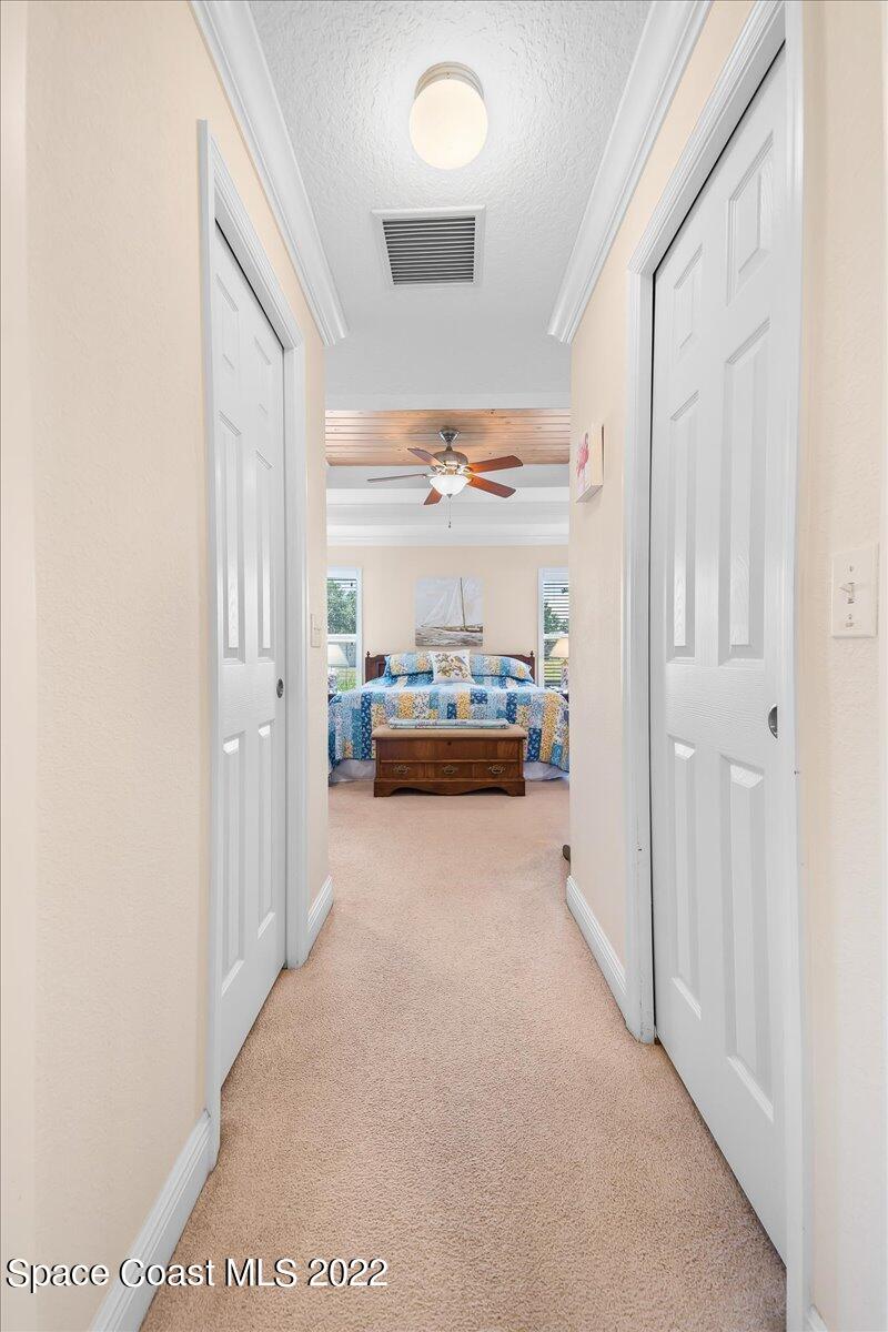5265 Evinrude Road Melbourne, FL 32934 - Photo 24 of 42 a view of hallway with livingroom and furniture
