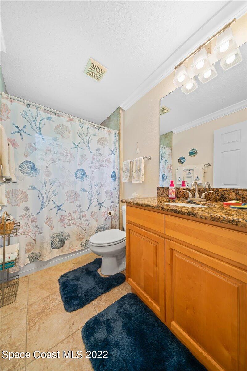 5265 Evinrude Road Melbourne, FL 32934 - Photo 27 of 42 a bathroom with a sink a toilet and shower