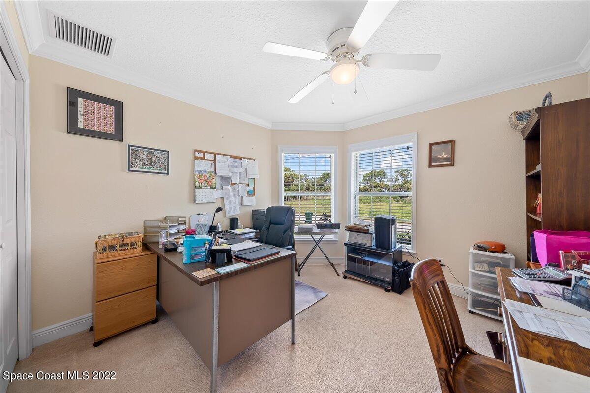 5265 Evinrude Road Melbourne, FL 32934 - Photo 28 of 42 a living room with furniture a window and a flat screen tv