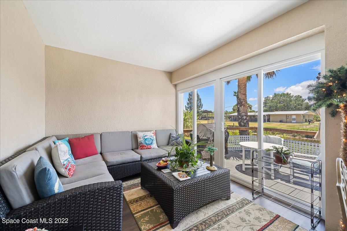 5265 Evinrude Road Melbourne, FL 32934 - Photo 29 of 42 a living room with furniture and a potted plant
