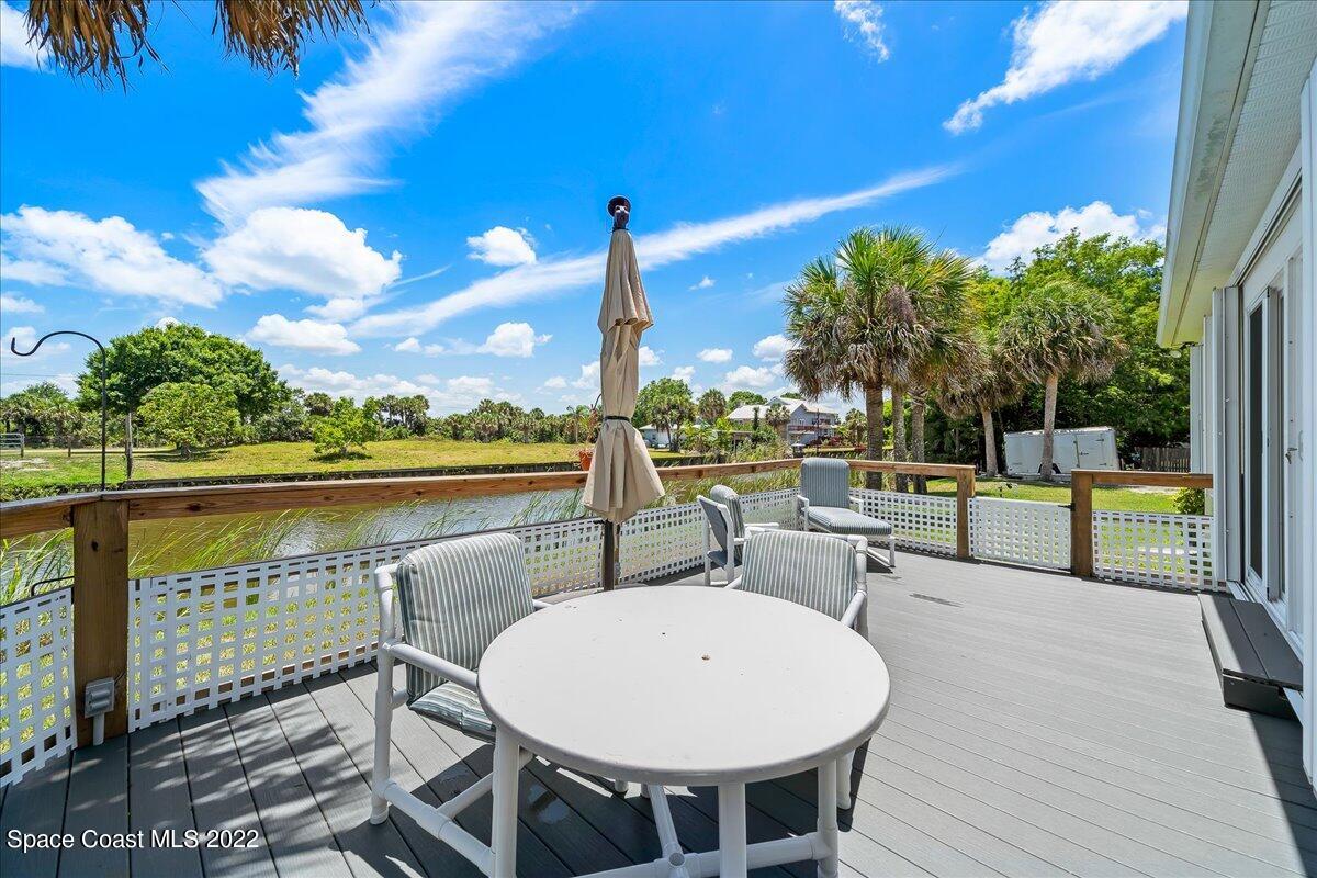 5265 Evinrude Road Melbourne, FL 32934 - Photo 32 of 42 a view of a swimming pool with a lounge chairs