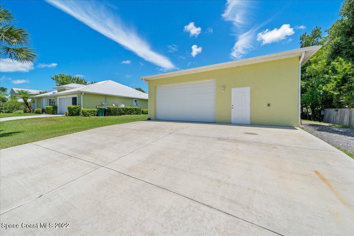 5265 Evinrude Road Melbourne, FL 32934 - Photo 37 of 42 a view of a house with a yard
