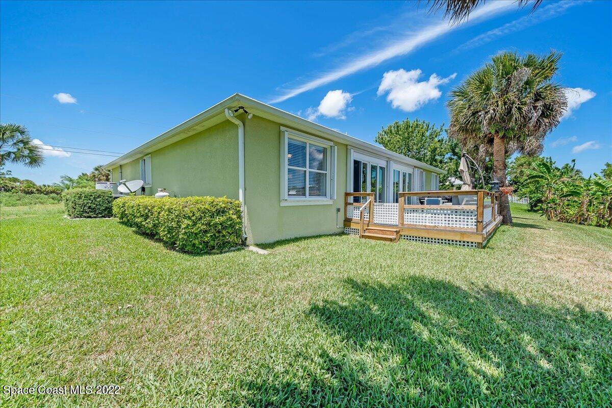 5265 Evinrude Road Melbourne, FL 32934 - Photo 39 of 42 a front view of a house with a yard