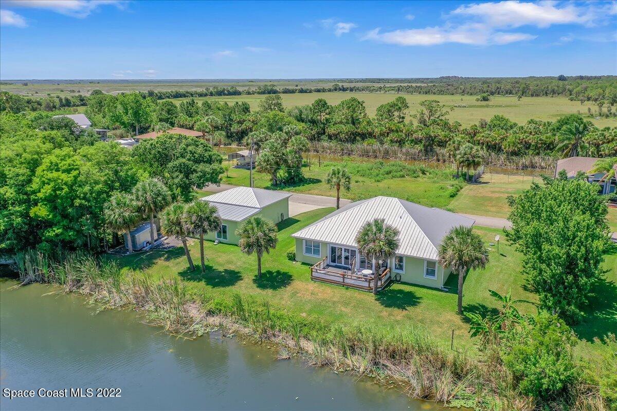 5265 Evinrude Road Melbourne, FL 32934 - Photo 41 of 42 a view of a lake with lawn chairs wooden floor and lake view