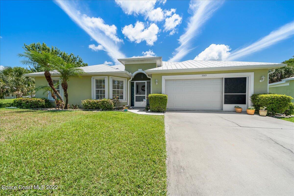 5265 Evinrude Road Melbourne, FL 32934 - Photo 5 of 42 a front view of a house with garden