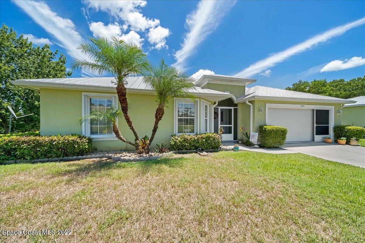 5265 Evinrude Road Melbourne, FL 32934 - Photo 6 of 42 a view of a house with backyard and a tree