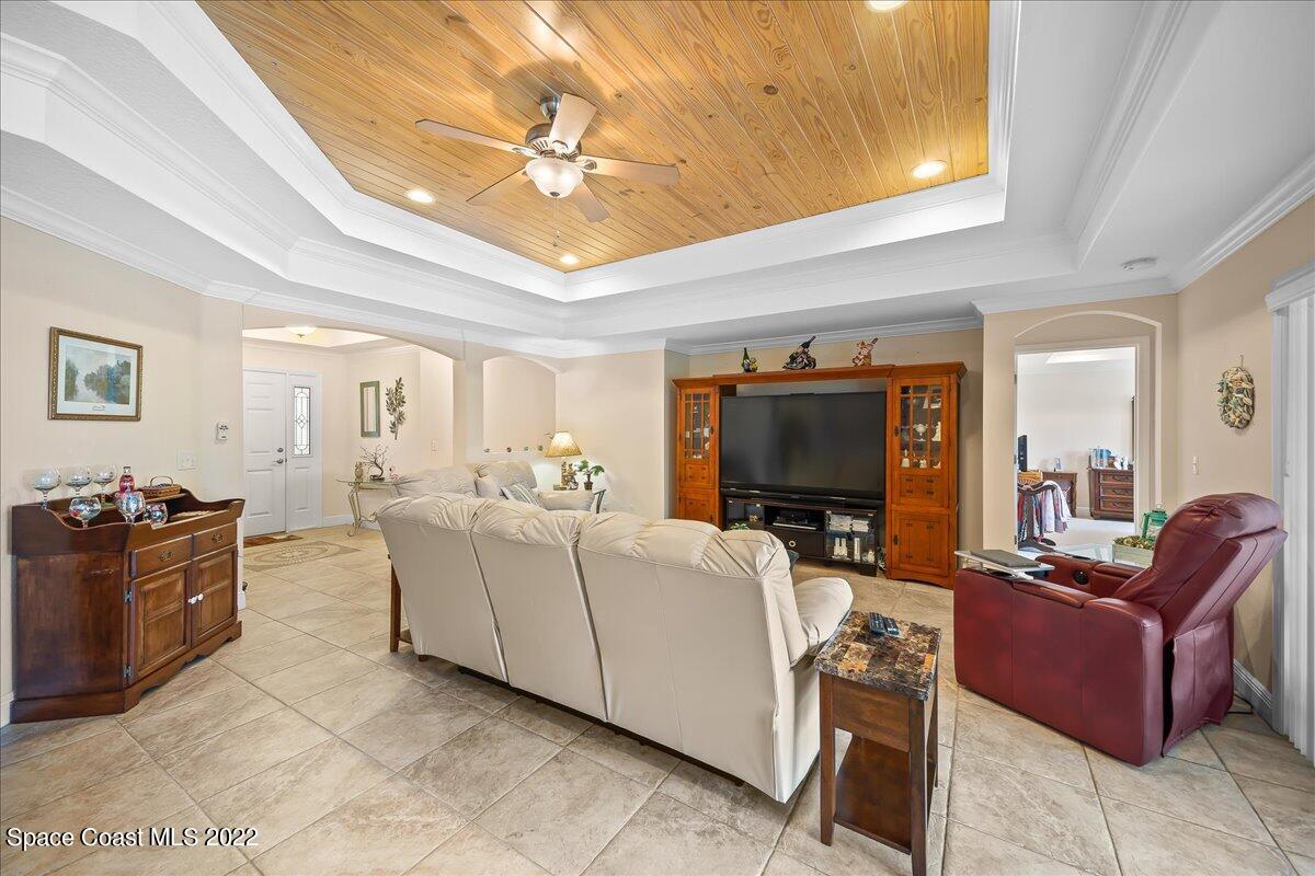 5265 Evinrude Road Melbourne, FL 32934 - Photo 9 of 42 a living room with furniture and a flat screen tv