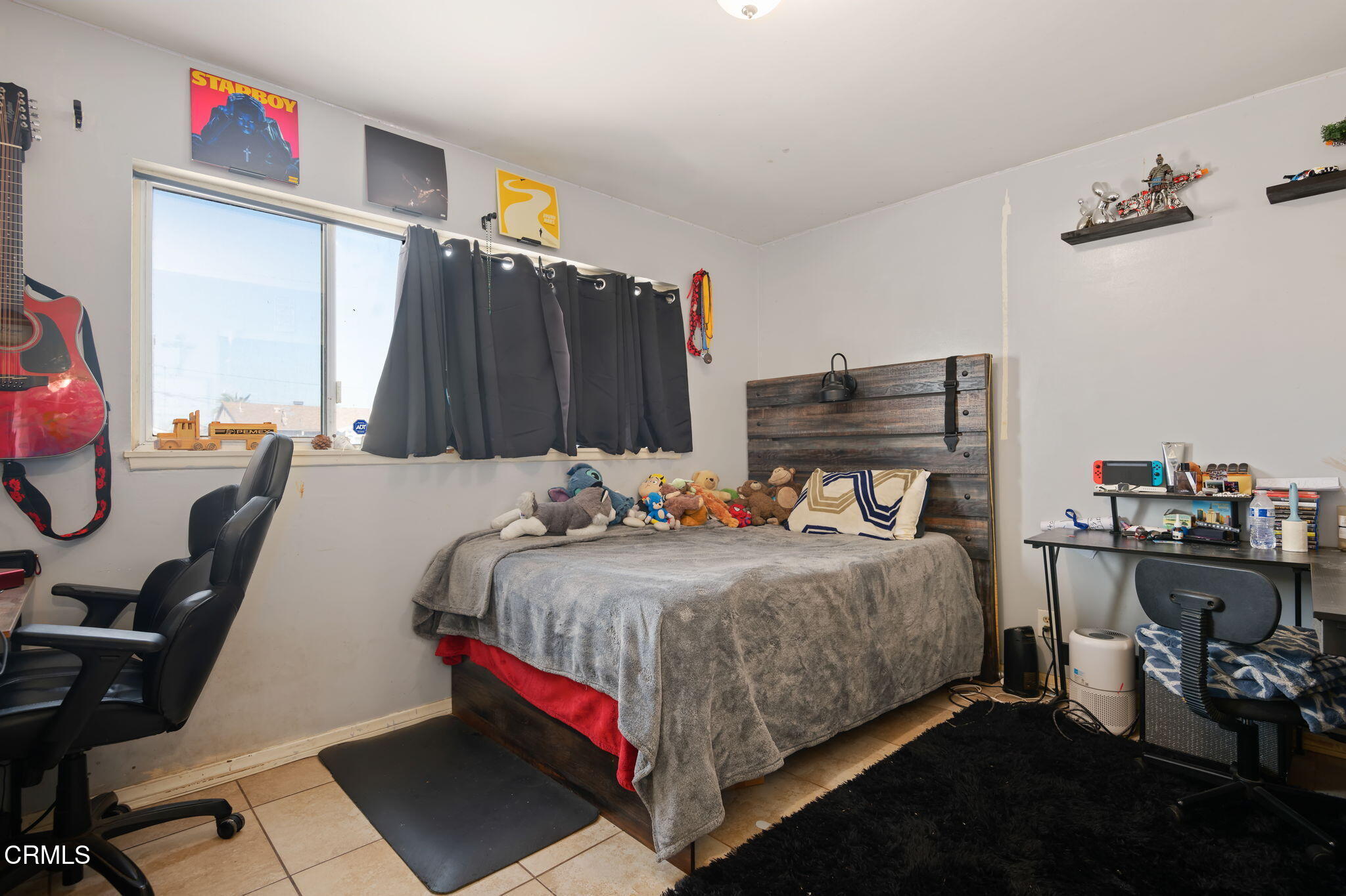 3050 Jackson Street Oxnard, CA 93033 - Photo 14 of 21 a bed room with a bed and a chair