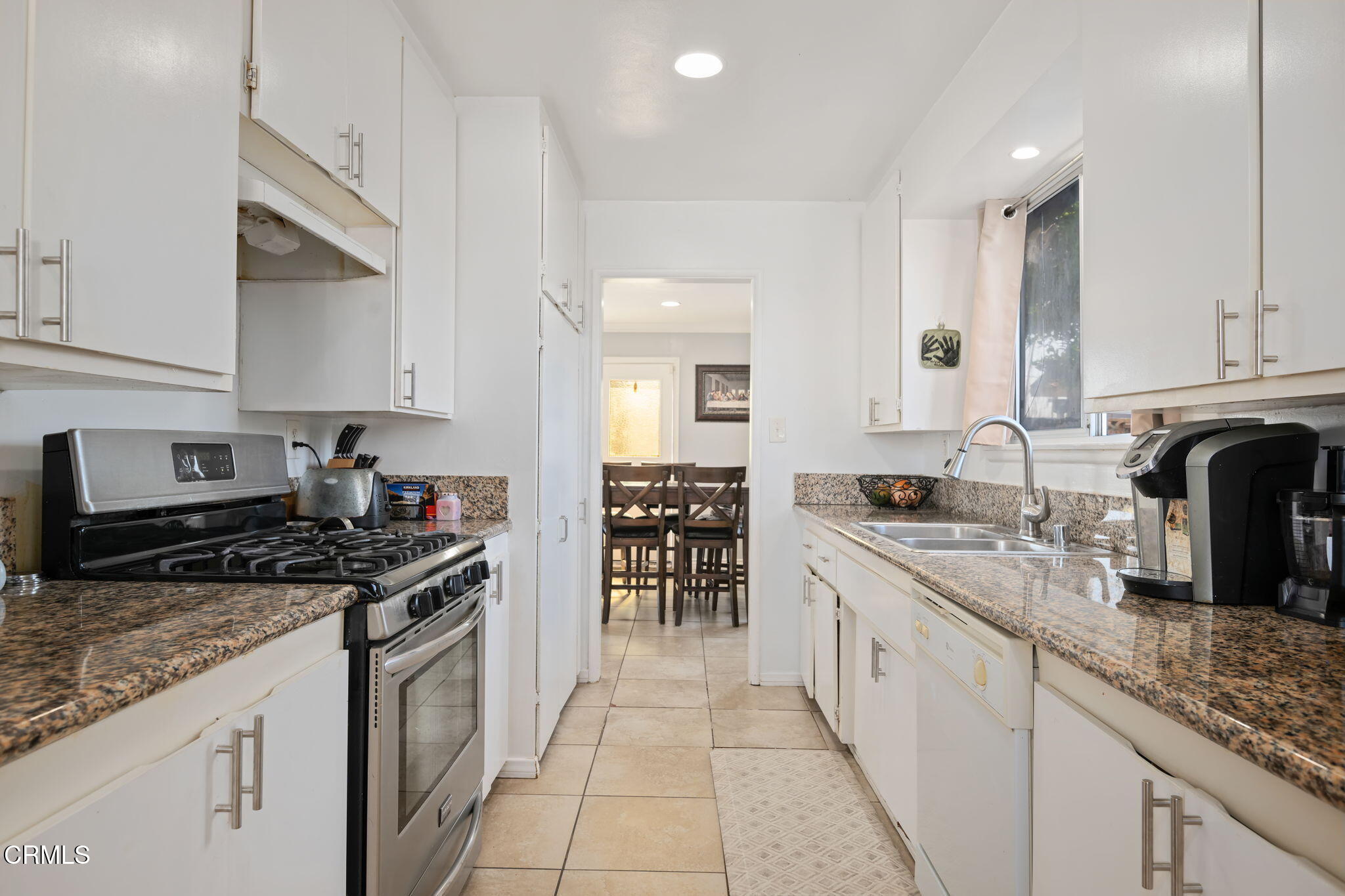 3050 Jackson Street Oxnard, CA 93033 - Photo 10 of 21 a kitchen with granite countertop a sink a stove and cabinets