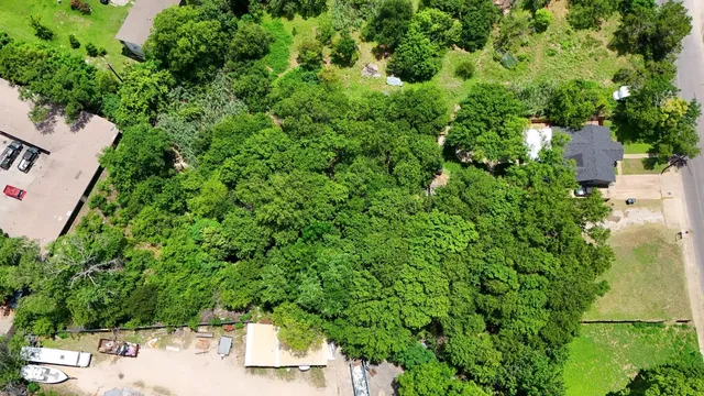 an aerial view of a house with yard