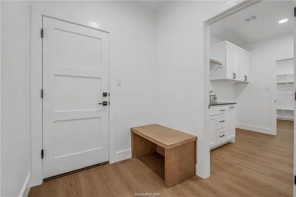 a view of cabinets and wooden floor