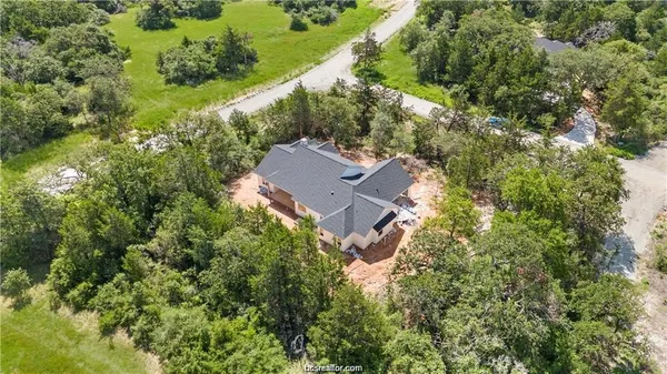 an aerial view of a house with a yard