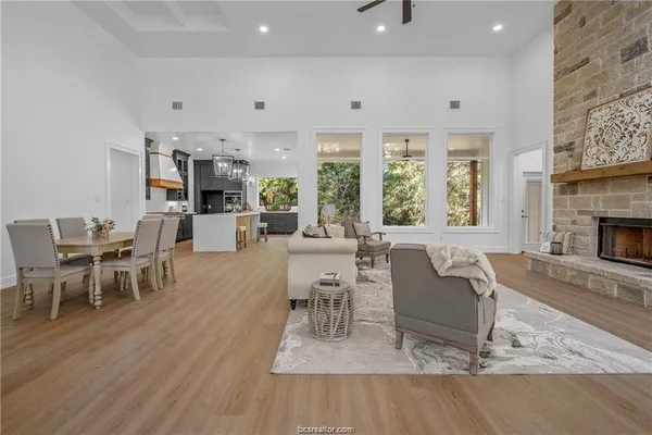 a living room with furniture a fireplace and a table