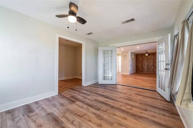 wooden floor in an empty room with a window