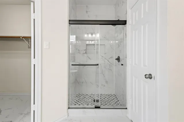 a bathroom with a glass shower door