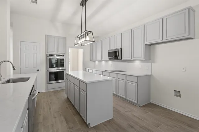 a kitchen with a sink stove and refrigerator