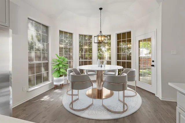 a dining room with furniture a chandelier and wooden floor