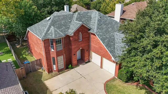 a aerial view of a house with a yard
