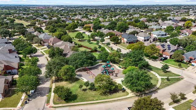 an aerial view of residential houses with outdoor space
