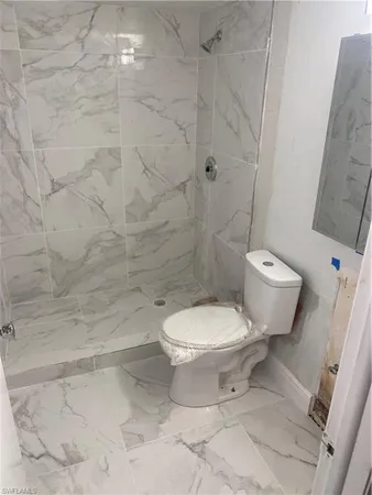 a bathroom with a toilet and a shower