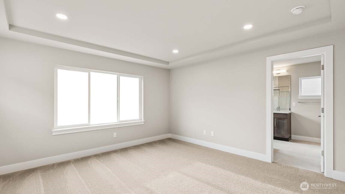 3125 194th Street Southeast Bothell, WA 98012 - Photo 18 of 25 an empty room with a window and a kitchen