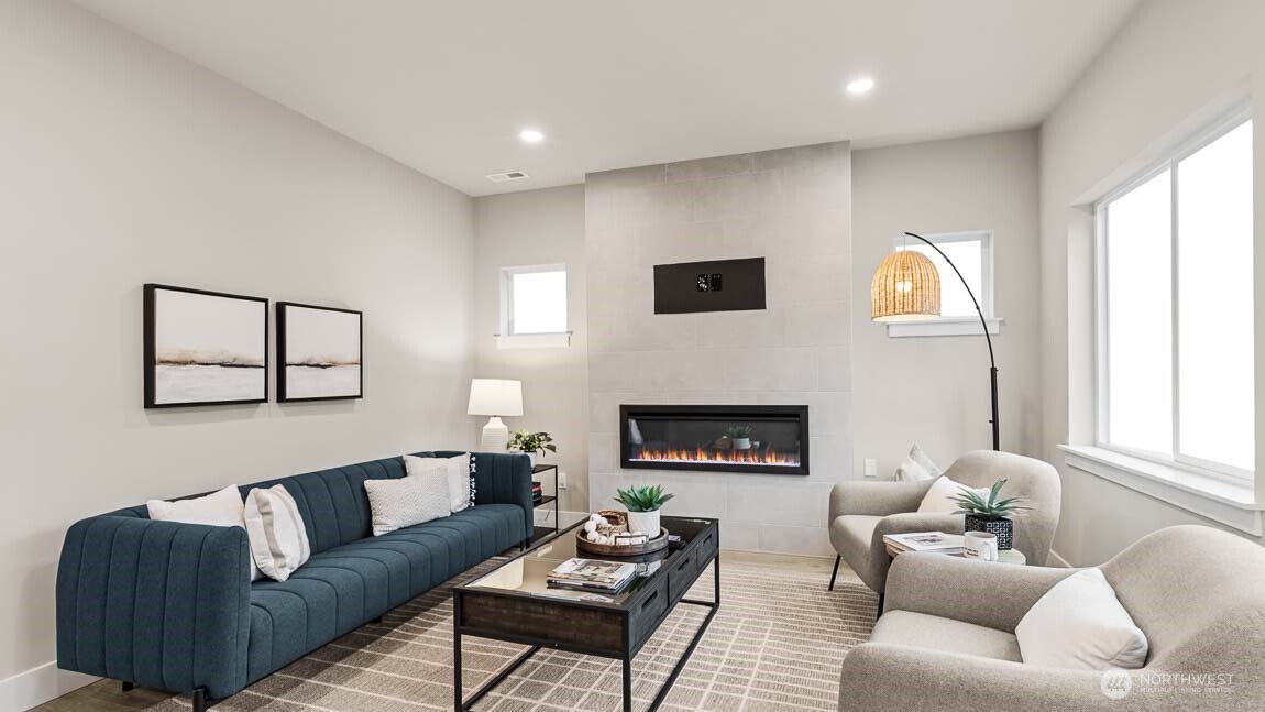 3125 194th Street Southeast Bothell, WA 98012 - Photo 9 of 25 a living room with furniture a fireplace and a flat screen tv