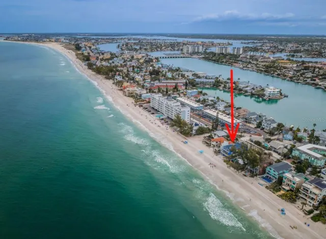 an aerial view of residential houses with outdoor space and parking