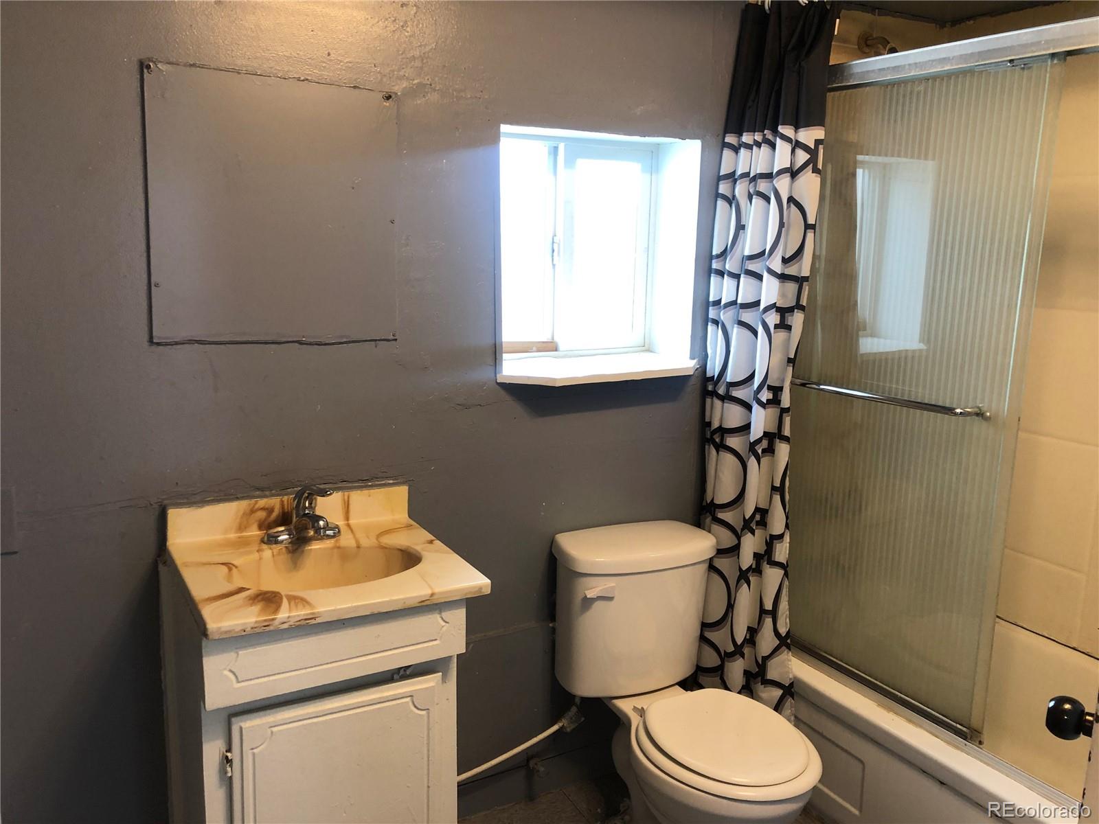 660 South Raleigh Street Denver, CO 80219 - Photo 13 of 21 a white toilet sitting next to a bathroom sink