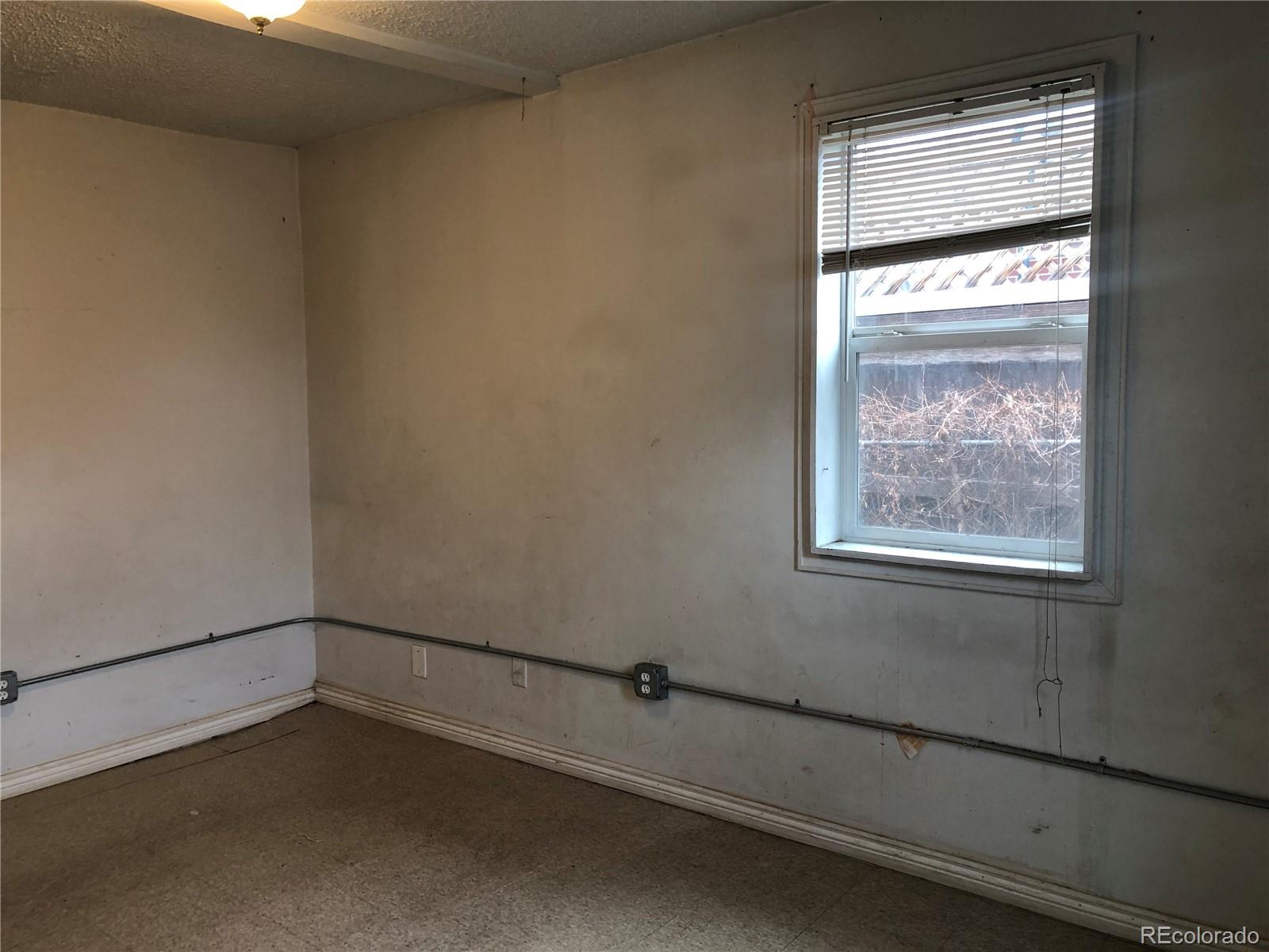 660 South Raleigh Street Denver, CO 80219 - Photo 16 of 21 an empty room with a window