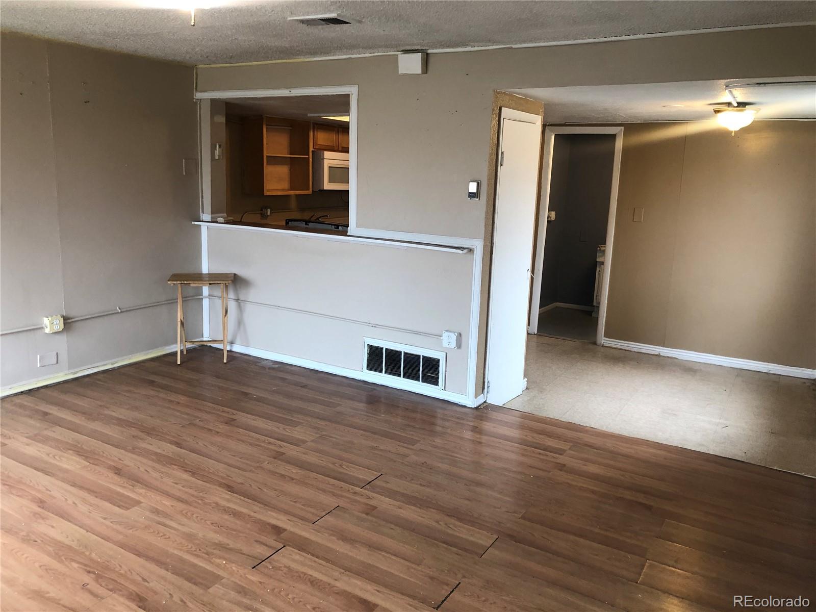 660 South Raleigh Street Denver, CO 80219 - Photo 7 of 21 a view of empty room with wooden floor