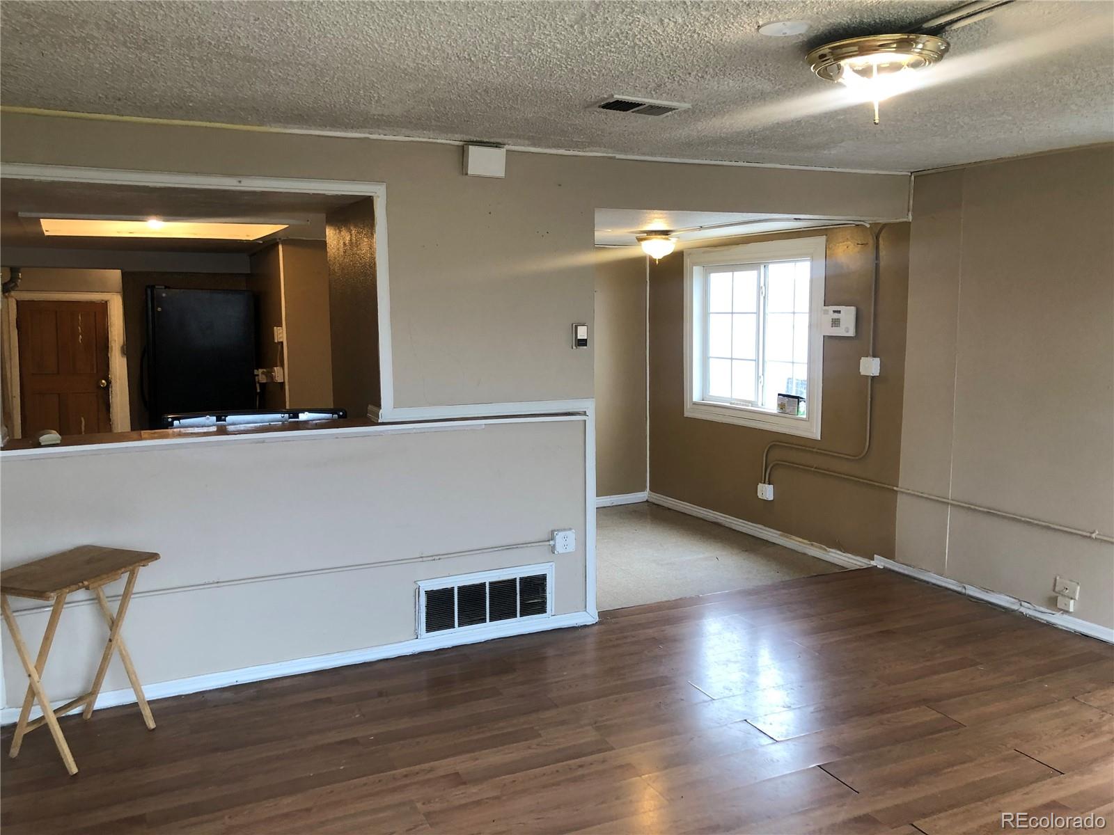 660 South Raleigh Street Denver, CO 80219 - Photo 8 of 21 a view of an empty room with wooden floor and a window