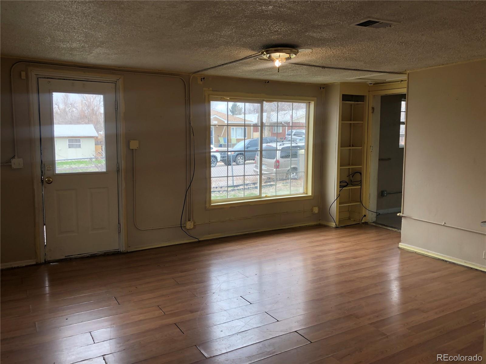 660 South Raleigh Street Denver, CO 80219 - Photo 10 of 21 an empty room with wooden floor and windows
