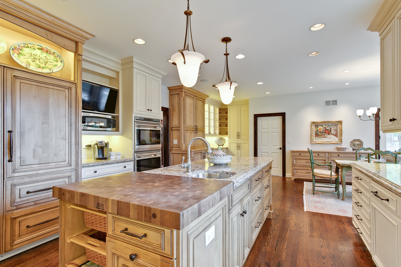 433 South Ridge Road Lake Forest, IL 60045 - Photo 17 of 49 a large kitchen with stainless steel appliances kitchen island granite countertop a stove a sink dishwasher and a flat tv screen next to a window