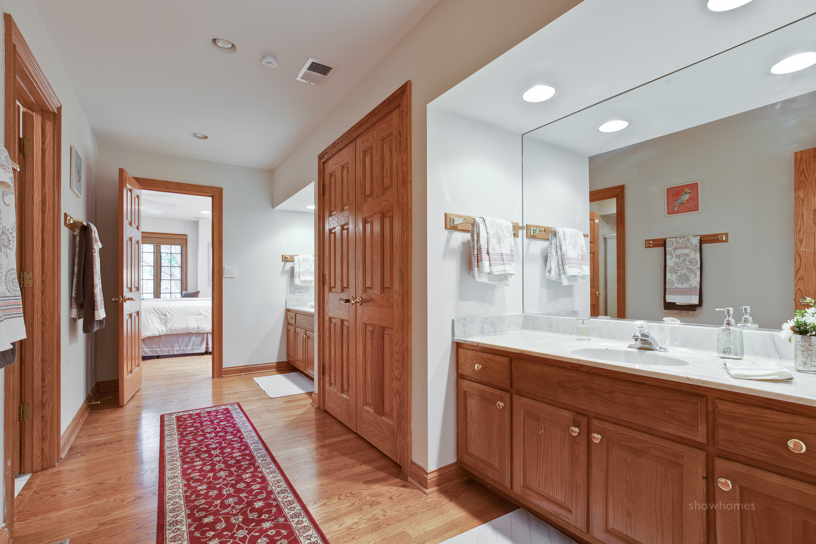 433 South Ridge Road Lake Forest, IL 60045 - Photo 31 of 49 a spacious bathroom with a shower sink and mirror