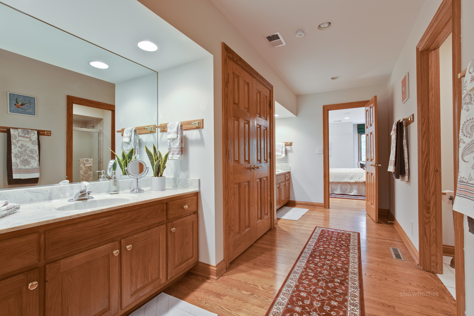 433 South Ridge Road Lake Forest, IL 60045 - Photo 32 of 49 a bathroom with a double vanity sink and mirror with shower