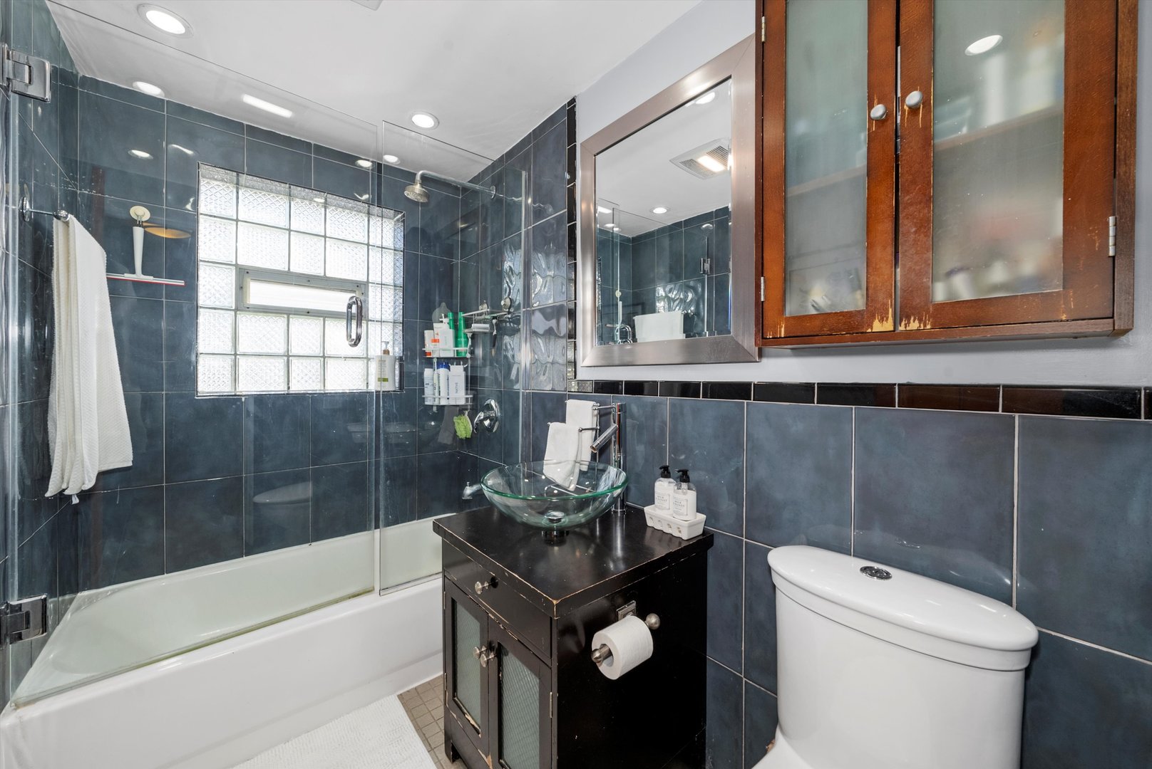 735 Forest Road La Grange Park, IL 60526 - Photo 14 of 31 a bathroom with a granite countertop sink a toilet a mirror and bathtub