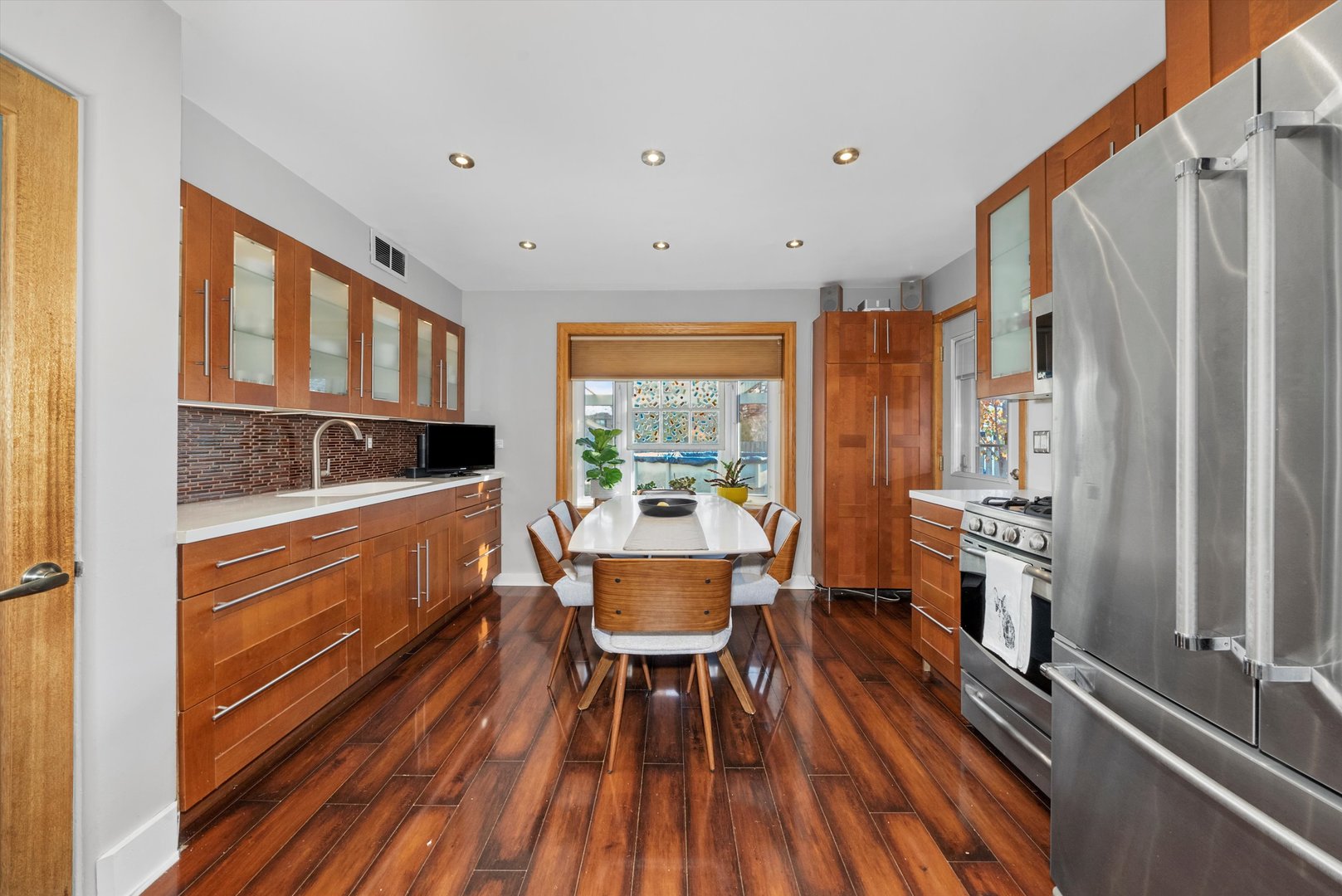 735 Forest Road La Grange Park, IL 60526 - Photo 3 of 31 a kitchen with a table chairs refrigerator and cabinets