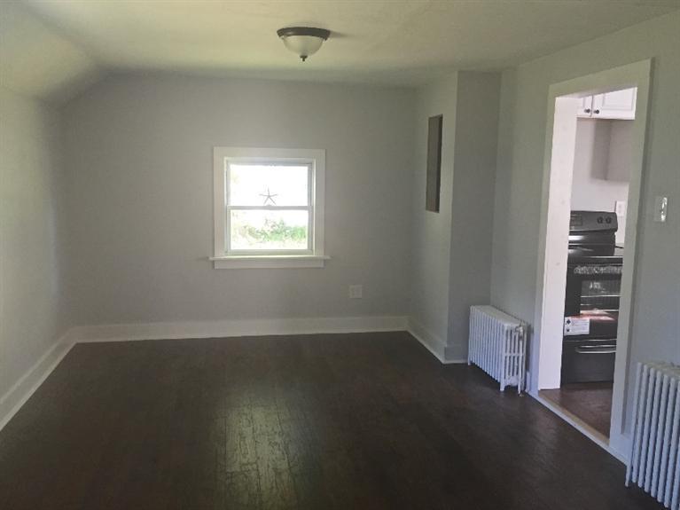 129 Spring Street Hyannis, MA 02601 - Photo 15 of 31 an empty room with a window and a fireplace