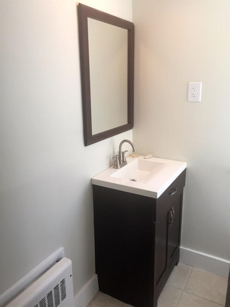 129 Spring Street Hyannis, MA 02601 - Photo 19 of 31 a utility room with a sink and a mirror