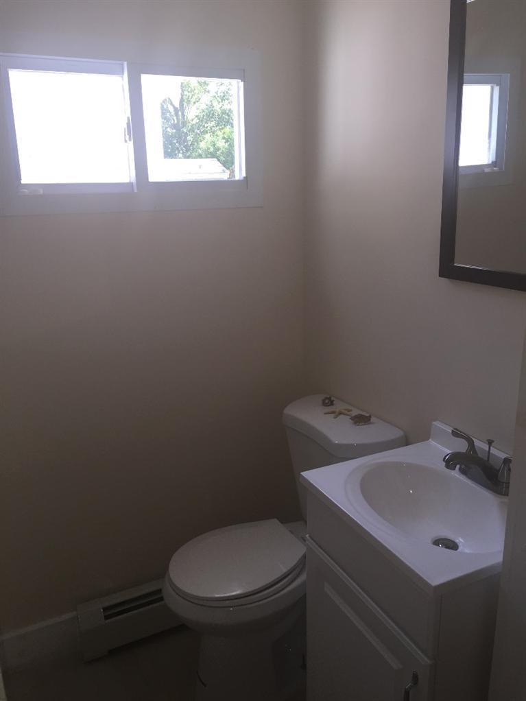 129 Spring Street Hyannis, MA 02601 - Photo 21 of 31 a bathroom with a toilet sink and mirror