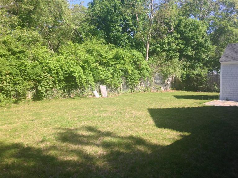 129 Spring Street Hyannis, MA 02601 - Photo 29 of 31 a view of yard with green space and trees in the background