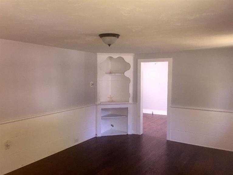 129 Spring Street Hyannis, MA 02601 - Photo 6 of 31 a room with wooden floor and white walls
