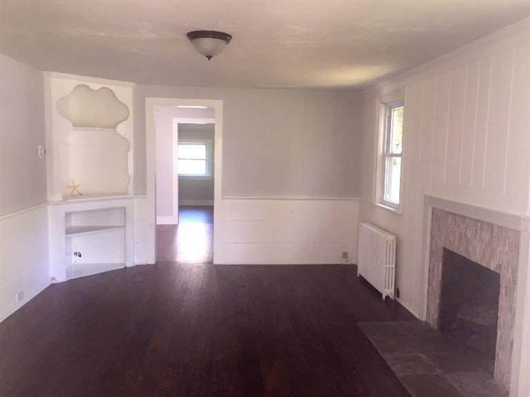 129 Spring Street Hyannis, MA 02601 - Photo 9 of 31 an empty room with windows and fireplace